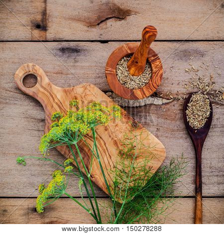 Close Up Blossoming Branch Of Fennel And Dried Fennel Seeds On Rustic Wooden Background With Flat La