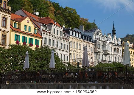 Street with historical buildings and bridge over the river Tepla in Karlovy Vary Czech Republic.