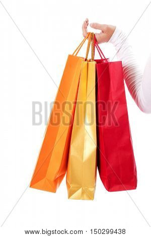 Isolated womans hand carries a shopping bag.
