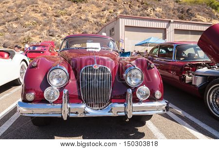 Laguna Beach, CA, USA - October 2, 2016: Red 1958 Jaguar XK 150 FHC owned by Frank Gauer and displayed at the Rotary Club of Laguna Beach 2016 Classic Car Show. Editorial use.