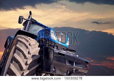 Tractor working on the farm, a modern agricultural transport, a farmer working in the field, tractor at sunset, modern tractor closeup