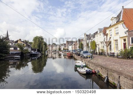 Maarssen, Netherlands, 30 september 2016: boats cars and houses along river Vecht in the dutch village of Maarssen in the netherlands