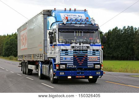KAARINA, FINLAND - SEPTEMBER 9, 2016: Customized Scania 143M 500 semi truck of L. Retva Oy and curtainsider trailer on the road in South of Finland.