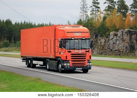 PAIMIO, FINLAND - SEPTEMBER 23, 2016: Orange Scania R400 semi cargo truck of TNT moves along motorway on a cloudy day of autumn in South of Finland. TNT Express is an international courier delivery services company with headquarters in Hoofddorp Netherlan