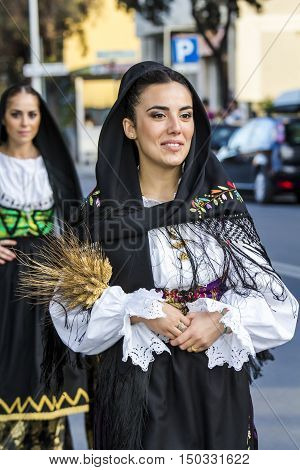 QUARTU S.E., ITALY - September 17, 2016: Parade of Sardinian costumes and floats for the grape festival in honor of the celebration of St. Helena. - Sardinia - portrait of a beautiful girl in traditional Sardinian costume