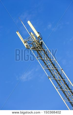 A high telecommunication network antenna and the beautiful clear blue sky
