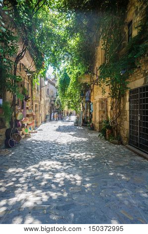 PERATALLADA, SPAIN - SEPTEMBER 26, 2015: The medieval cobbled streets of Peratallada in Catalonia Spain