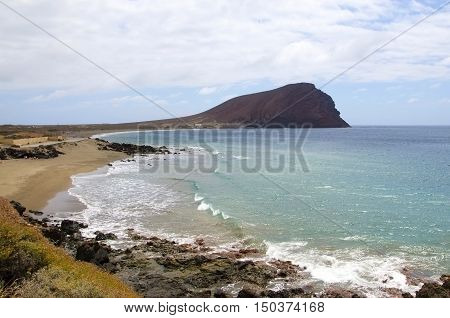 Beach Playa de la Tejita with Montaña Roja red montain. Tenerife Canary Island Spain