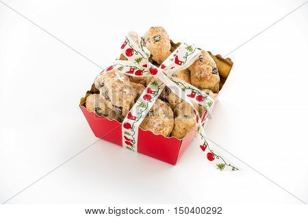 Mini Christstollen in a festive red tray decorated with ribbon isolated on white background.