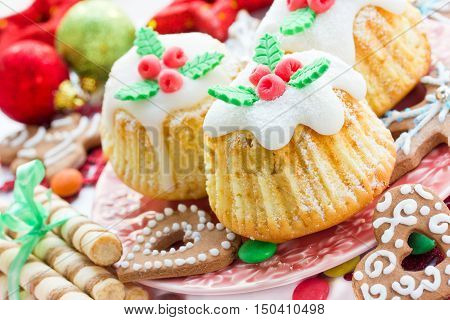 Traditional cuisine. Christmas treats cupcakes cookies on a festive table close up selective focus