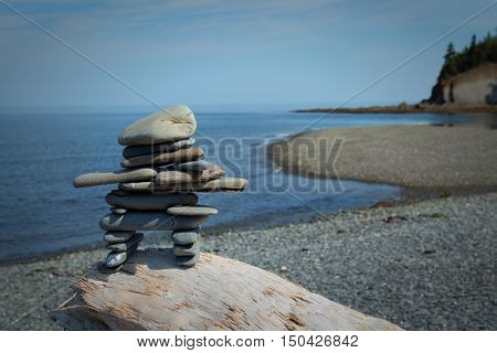 Inukuk standing on a rock in gaspesie, Quebec. An inuksuk is a human-made stone landmark.