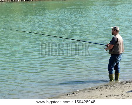 a fisherman fishing on the adda  river