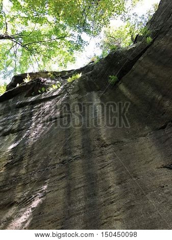 The sunlight shining on the rocks at Kinzua and the bright green trees.
