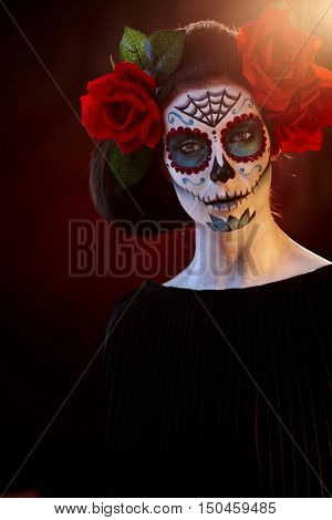 Woman in Halloween makeup - mexican Santa Muerte mask.