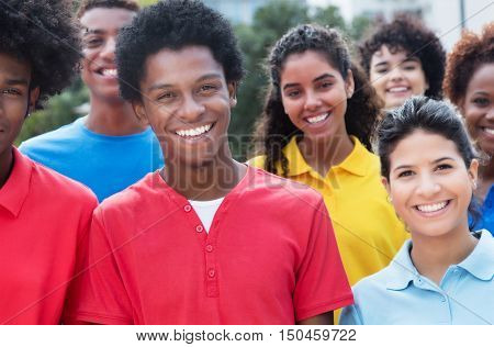 Mixed group of happy multiethnic young adults outdoor in the city in the summer
