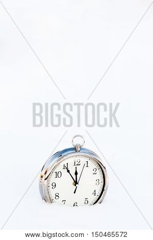 Metallic old clock in snow copy space. New year greeting card christmas concept.