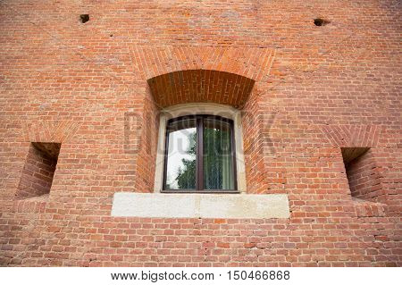 single window on brick building wall. brick wall with a window