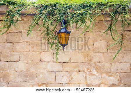 lantern in stone brick wall. Stone wall of an ancient Lantern. Old