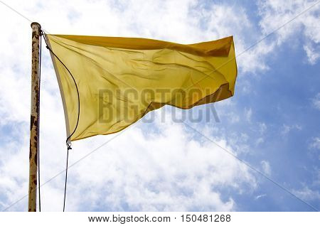 Yellow flag waving over the blue sky. Promotional and advertisement