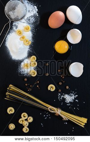 Traditional And Black Uncooked Italian Pasta Linguine With White And Brown Chicken Eggs