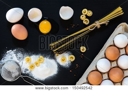 Traditional And Black Uncooked Italian Pasta Linguine With White And Brown Chicken Eggs
