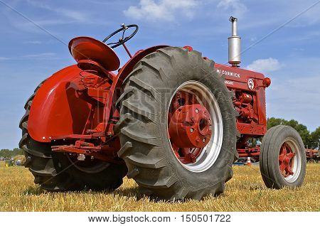 ROLLAG, MINNESOTA, Sept 1. 2016: An old restored classic McCormick tractor is  displayed at the West Central Steam Threshers Reunion in Rollag, MN attended by 1000's held annually on Labor Day weekend.
