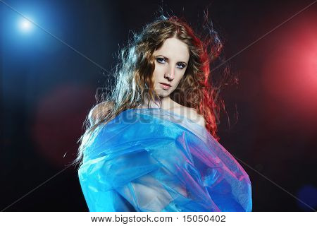 Portrait Of The Young Dancing Woman Against Color Flashes