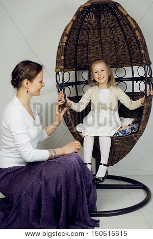 young mother with daughter at luxury home interior vintage, old fashion relashionship family