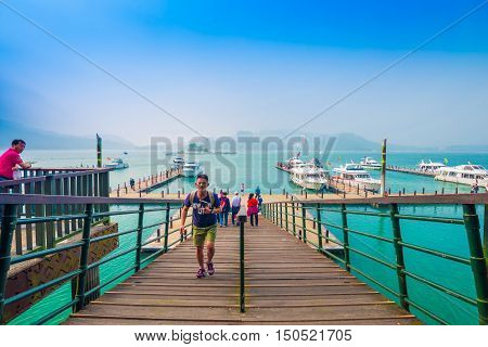 SUN MOON LAKE - MARCH 20: Tourist with boats parking at the pier on March 20 2015 at Sun Moon Lake Taiwan. Sun Moon Lake is the largest body of water in Taiwan as well as a tourist attraction.