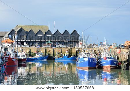 Whitstable United Kingdom - Otcober 1 2016: Fishing Boats and fishermans sheds in Whitstable Harbour