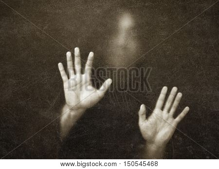 Shadowy figure behind dusty scratched glass