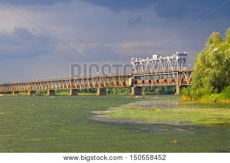 Bridge across river Dnieper in Kremenchug and storm clouds in sky