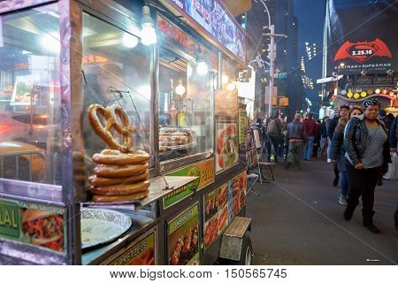 NEW YORK - CIRCA MARCH, 2016: street food cart in New York City. Street food is ready-to-eat food or drink sold by a hawker, or vendor, in a street or other public place, such as at a market or fair.