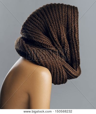 Fashion beautiful woman in warm knitted scarf. Autumn color. Studio shoot