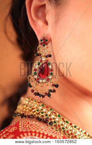 beautiful Indian woman in a sari traditional dress on an abstract yellow background