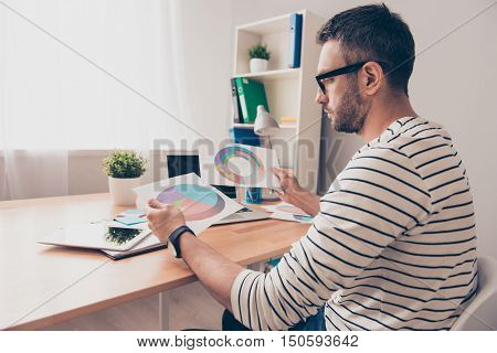 man in glasses working with diagramas on the white