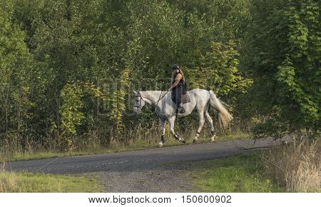 Fat Woman On White Horse Near Milada Lake