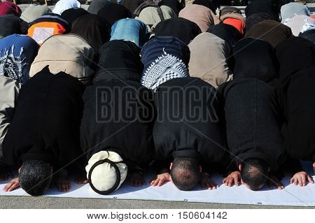Men during a mass muslim prayer session