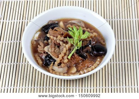 Mixed vegetable and tofu sheet in brown soup call 