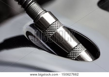 Close-up of electric guitar cable jack pluged