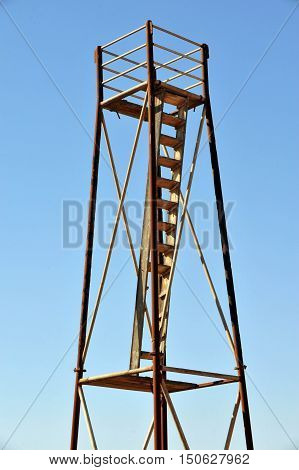 An old watchtower in Israel over blue sky.