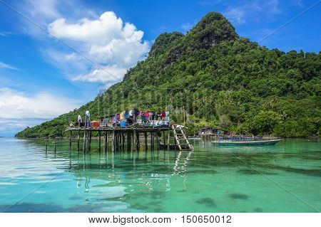 The traditional sea gypsy water village with the unique boat in Bodgaya Island at Semporna,Sabah,Borneo,Malaysia.One of the main attraction of Semporna with clear blue water,sand & palm trees.