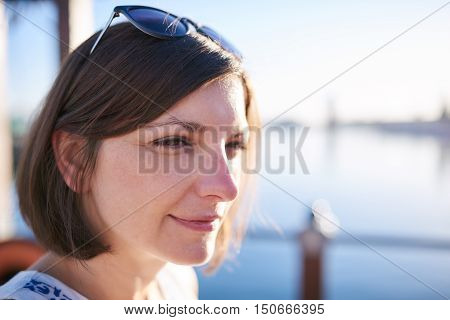 Attractive mature white woman busy looking off camera early in the morning with brwon hair cut in a bob style with copy space to one side.