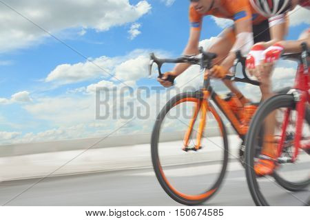 Group of cyclist during a race motion blur sky in the background
