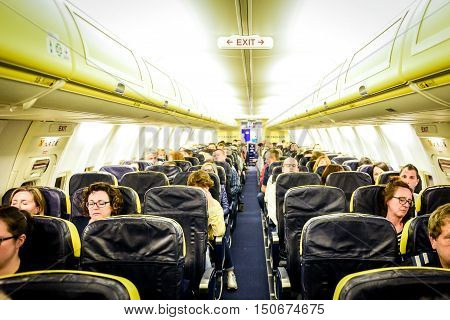 Trieste Italy - May 23 2016: People are sitting on Ryanair flight from Trieste - Italy to Valencia - Spain. The inside of low-cost budget airline commercial plane Boeing 737-800.