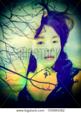 de-focused Beautiful sexy woman in black lace lingerie with double exposure of sunset scene and silhouette of tree black vignette
