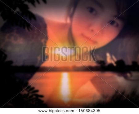 de-focused Beautiful sexy woman in black lace lingerie lying on her stomach on her bed with double exposure of sunset scene black vignette