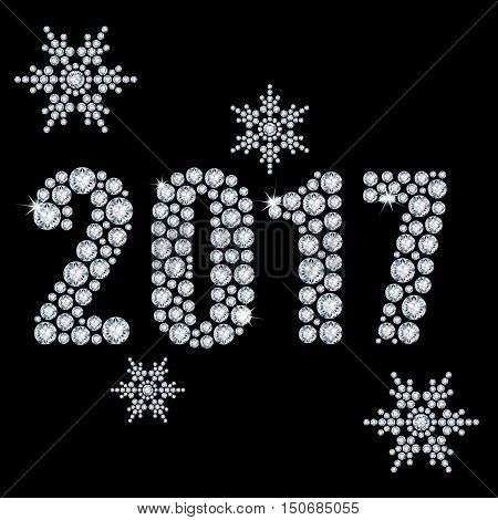 The new 2017 year diamond on a black background and snowflakes