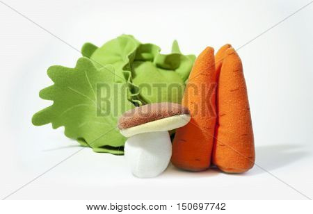 Fake varied vegetables: mushroom cabbage carrots. Kids vegetable toys.