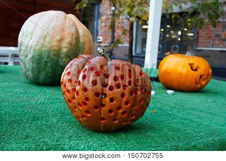 Halloween still life with orange and greenpumpkins closeup